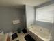 Bright bathroom with a tub, a vanity and a window for natural light at 181 Mott Rd, Mooresville, NC 28115