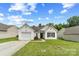 Charming single-story home features a manicured lawn and attached one-car garage at 181 Mott Rd, Mooresville, NC 28115