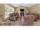 Spacious living room features a cozy fireplace, large window, and comfortable seating at 181 Mott Rd, Mooresville, NC 28115