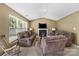 Bright living room features a fireplace, comfortable seating, and large window at 181 Mott Rd, Mooresville, NC 28115