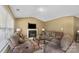 Cozy living room featuring a fireplace, comfortable seating, and neutral decor at 181 Mott Rd, Mooresville, NC 28115