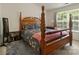 Bedroom with four poster bed, area rug and natural light from the window at 181 Mott Rd, Mooresville, NC 28115