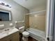 Bathroom with a bathtub/shower combination, classic fixtures, and tile accents at 2020 Longleaf Dr, Charlotte, NC 28210