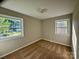 Inviting bedroom with neutral walls, plush carpeting, and two windows providing natural light at 2020 Longleaf Dr, Charlotte, NC 28210