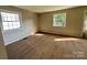 Cozy bedroom with neutral walls, plush carpeting, and bright natural light from two windows at 2020 Longleaf Dr, Charlotte, NC 28210