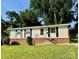 Charming single-story home featuring black window shutters and a well-maintained front yard at 2020 Longleaf Dr, Charlotte, NC 28210