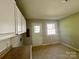 Bright kitchen featuring white cabinets and a back door offering easy outdoor access at 2020 Longleaf Dr, Charlotte, NC 28210
