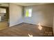Inviting living room featuring neutral walls, plush carpeting, and bright natural light from the window at 2020 Longleaf Dr, Charlotte, NC 28210