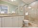 Bright bathroom with white cabinets, a granite countertop, and a glass-enclosed shower at 2129 Halford Pl, Charlotte, NC 28211