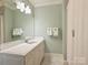 Bathroom featuring a large mirror, white marble vanity, and a walk-in shower at 2129 Halford Pl, Charlotte, NC 28211