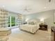 Serene bedroom featuring large windows, a cozy seating area, and soft, natural light at 2129 Halford Pl, Charlotte, NC 28211