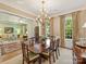 Elegant dining room with chandelier, hardwood floors, and formal furnishings at 2129 Halford Pl, Charlotte, NC 28211