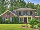 Stately two-story brick home with manicured lawn and mature trees at 2129 Halford Pl, Charlotte, NC 28211