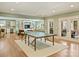 Spacious game room with ping pong table, hardwood floors, and access to outdoor patio at 2129 Halford Pl, Charlotte, NC 28211