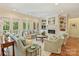 Bright living room with fireplace, built-in shelving, and multiple windows at 2129 Halford Pl, Charlotte, NC 28211