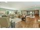 Open-concept living area with hardwood floors, comfortable seating, and abundant natural light at 2129 Halford Pl, Charlotte, NC 28211