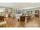 Expansive living area with hardwood floors, built-in shelving, and stainless steel appliances at 2129 Halford Pl, Charlotte, NC 28211
