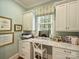 Well-lit home office with built-in cabinets, desk space, and window at 2129 Halford Pl, Charlotte, NC 28211