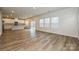 Expansive living area with wood floors, flowing into a white kitchen and dining area at 2159 Sunflower Cir, Newton, NC 28658