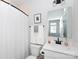 Clean, bright bathroom with a white vanity, stylish mirror, and fresh white shower curtain at 2254 Electric Ln, Charlotte, NC 28205