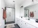 Bathroom featuring a glass-enclosed shower, white cabinets, and modern fixtures at 2254 Electric Ln, Charlotte, NC 28205