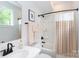 Bright bathroom with modern fixtures, white vanity, and tiled shower/tub combo at 2254 Electric Ln, Charlotte, NC 28205