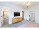 Primary bedroom with an ensuite bathroom, and a large television at 2254 Electric Ln, Charlotte, NC 28205