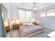 Bedroom with neutral tones, a brass pendant light, and large windows at 2254 Electric Ln, Charlotte, NC 28205
