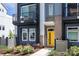 Charming townhome with a welcoming yellow front door and well-maintained landscaping, creating curb appeal at 2254 Electric Ln, Charlotte, NC 28205