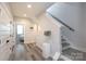 Bright hallway featuring hardwood floors, white trim, and staircase at 2254 Electric Ln, Charlotte, NC 28205