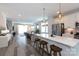 Modern kitchen with stainless steel appliances, white cabinets, and a breakfast bar that opens to the living area at 2254 Electric Ln, Charlotte, NC 28205