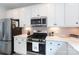 Bright kitchen with stainless steel appliances, white cabinets and countertops, and ample space for meal prep at 2254 Electric Ln, Charlotte, NC 28205