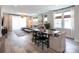Open-concept living and dining area with contemporary furnishings and hardwood floors, perfect for entertaining at 2254 Electric Ln, Charlotte, NC 28205
