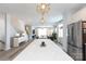 Modern living room featuring a white kitchen island, stainless steel appliances, and hardwood floors throughout at 2254 Electric Ln, Charlotte, NC 28205