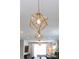 A pair of gold geometric pendant lights illuminate the open floor plan at 2254 Electric Ln, Charlotte, NC 28205