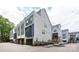 Street view of modern townhomes with attached garages and varied exterior designs at 2254 Electric Ln, Charlotte, NC 28205