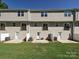 Backyard of a townhouse showcasing a private patio and well-maintained lawn at 2715 Sydney Overlook Ln, Charlotte, NC 28269