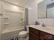 Bright bathroom with a large vanity, bathtub with shower, and neutral color palette at 2715 Sydney Overlook Ln, Charlotte, NC 28269