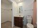 Well-lit bathroom featuring a vanity with a dark wood cabinet and a large mirror at 2715 Sydney Overlook Ln, Charlotte, NC 28269