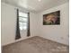 Cozy bedroom featuring a window with curtains, neutral paint, and plush carpet at 2715 Sydney Overlook Ln, Charlotte, NC 28269