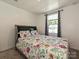 Bright bedroom with a floral comforter and a window providing natural light at 2715 Sydney Overlook Ln, Charlotte, NC 28269