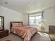Cozy bedroom with plush carpet and natural light from the large window at 2715 Sydney Overlook Ln, Charlotte, NC 28269