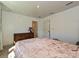 Bright bedroom with a large dresser, warm carpeting, and a comfortable bed at 2715 Sydney Overlook Ln, Charlotte, NC 28269