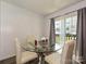 Bright dining area features a glass table with four chairs and sliding glass doors at 2715 Sydney Overlook Ln, Charlotte, NC 28269