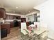 Open floor plan with view from dining area, showcasing kitchen with dark cabinetry and living space at 2715 Sydney Overlook Ln, Charlotte, NC 28269