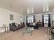 Bright living room featuring neutral carpet, comfortable seating, and lots of natural light through curtained windows at 2715 Sydney Overlook Ln, Charlotte, NC 28269