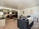 Open-concept living room flows into a kitchen with rich wood cabinets and modern black appliances at 2715 Sydney Overlook Ln, Charlotte, NC 28269