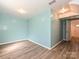 Spacious room featuring light blue walls and wood-look floors, with ample natural light at 2715 Sydney Overlook Ln, Charlotte, NC 28269