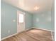 A versatile room featuring light blue walls and wood-look floors, perfect for an office or bedroom at 2715 Sydney Overlook Ln, Charlotte, NC 28269