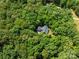 Overhead view of the home surrounded by dense green foliage, showcasing its secluded location and natural beauty at 300 Hugh Crocker Rd, Matthews, NC 28104